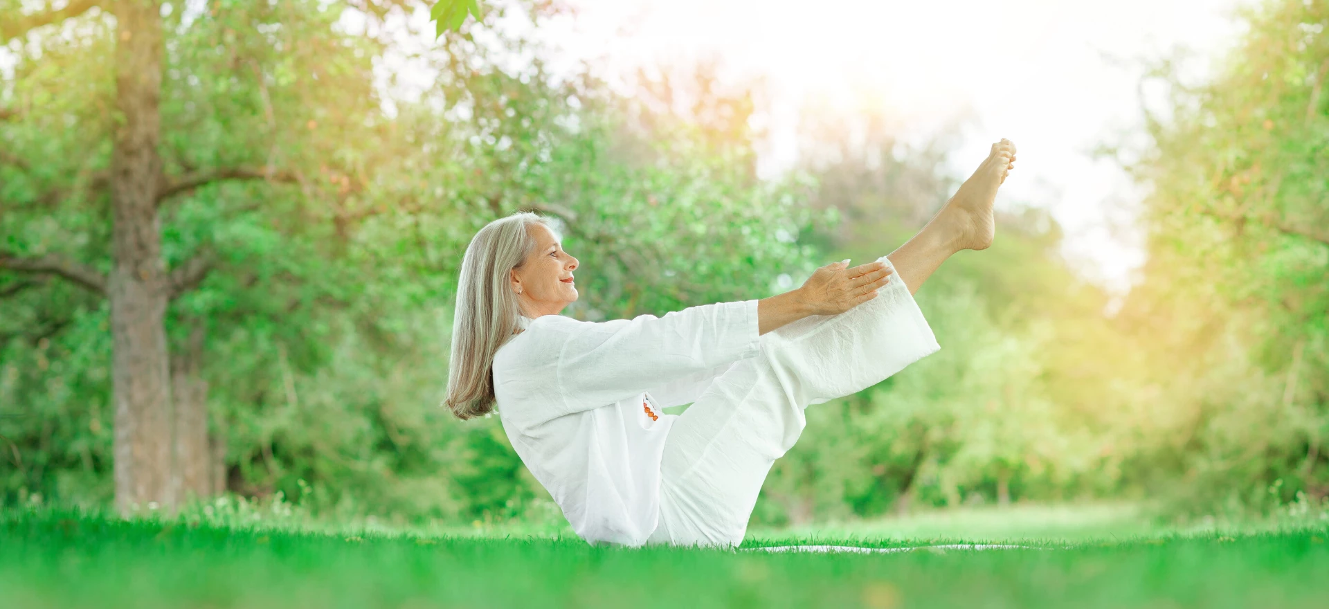 Woman practicing yoga navasana boat pose.