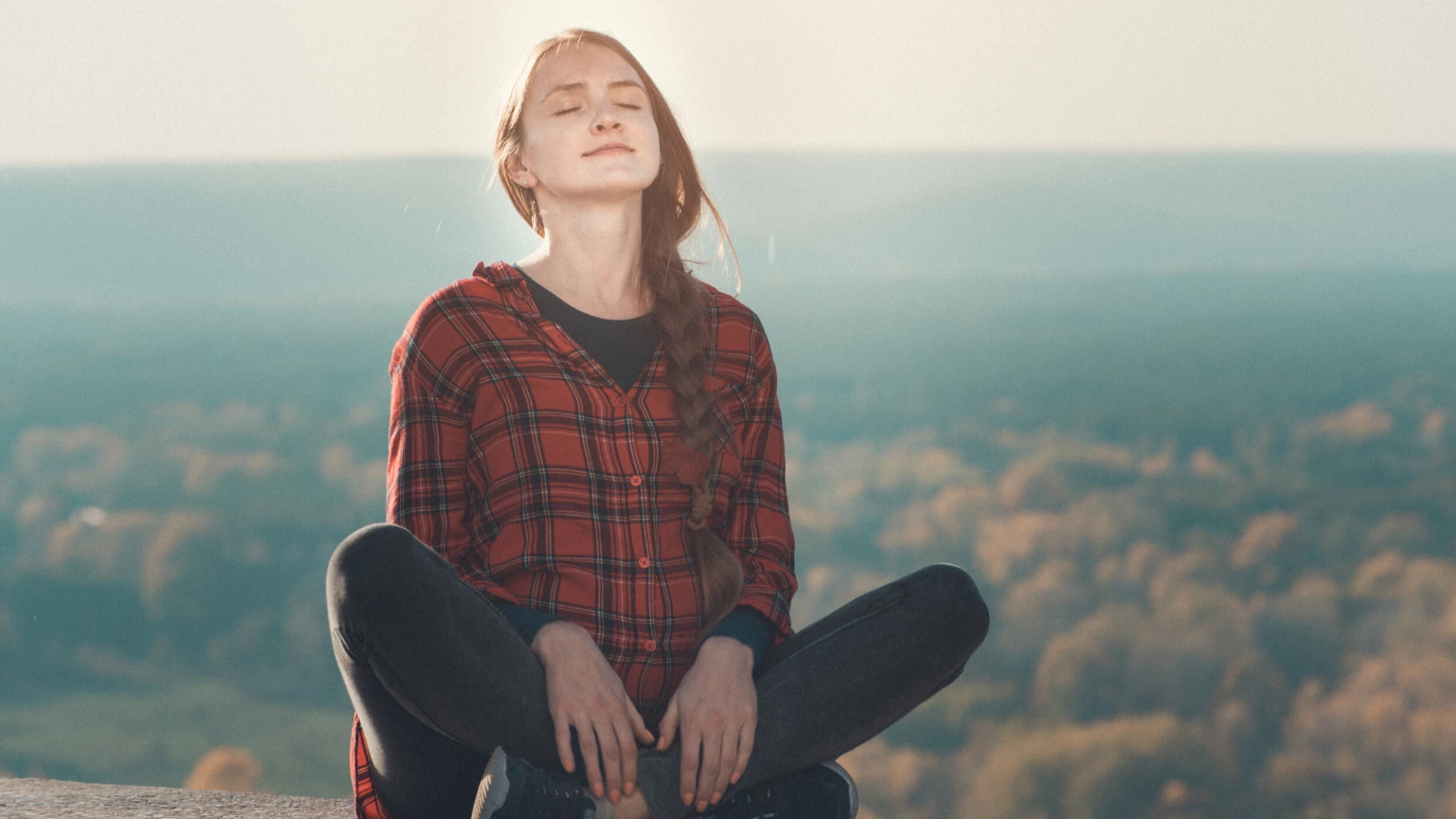 Female yoga student practicing meditation outdoor. 