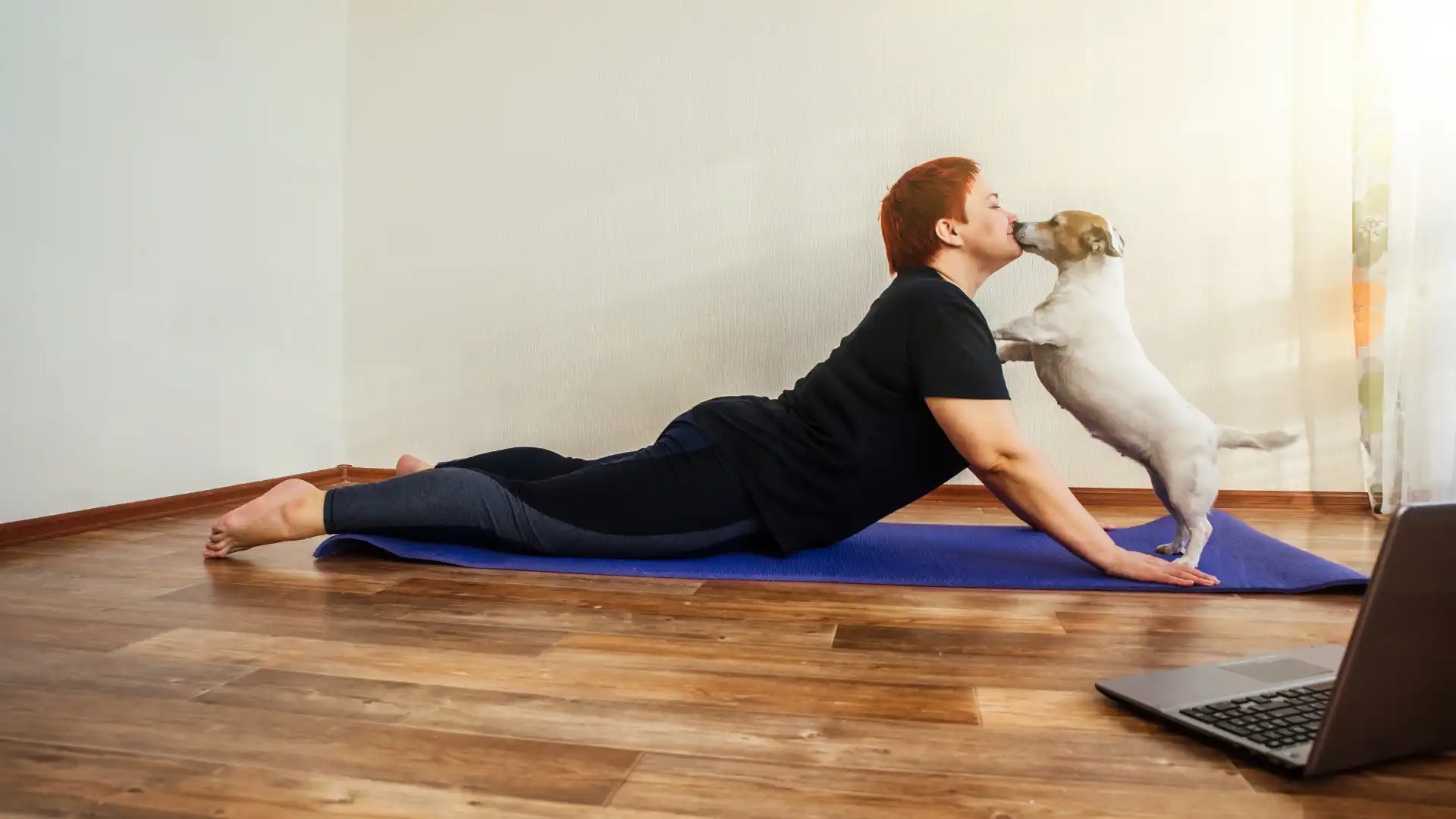 Woman practicing yoga online at home.