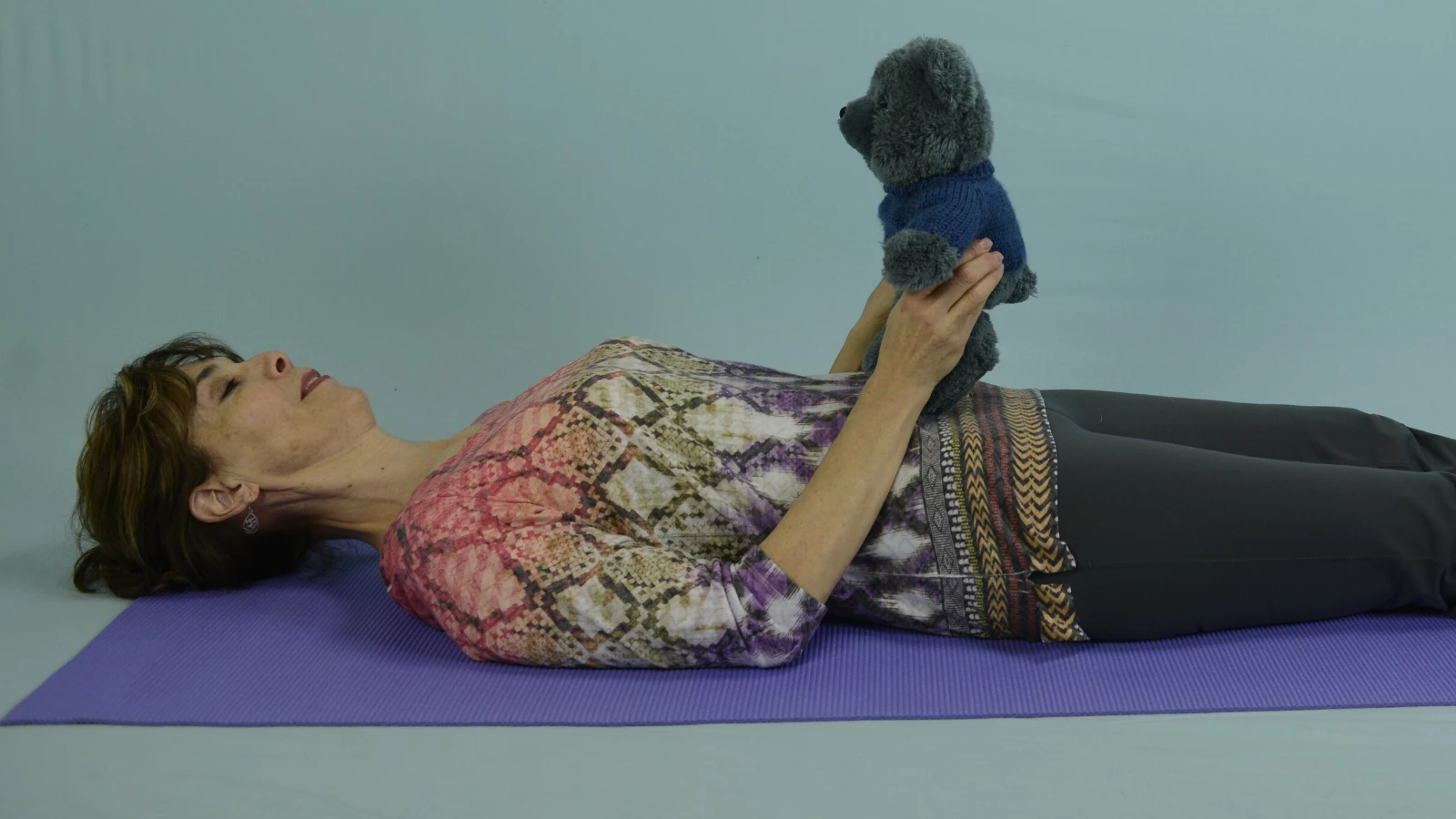 Yoga teacher demonstrating breathing techniques (pranayama) for children 