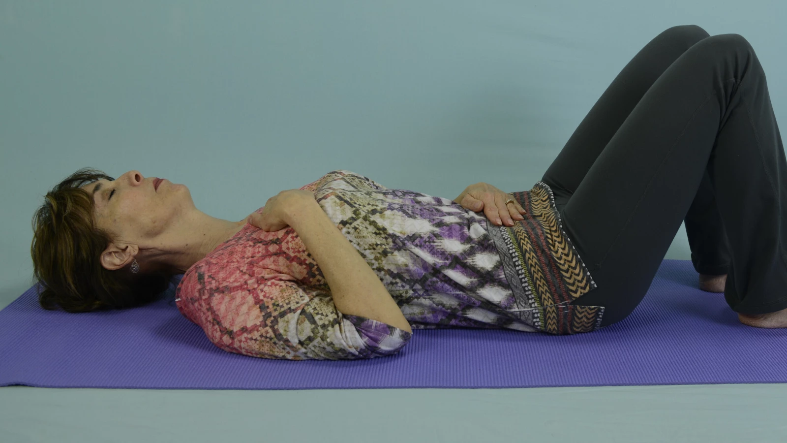 Yoga teacher demonstrating breathing techniques (pranayama) for children 