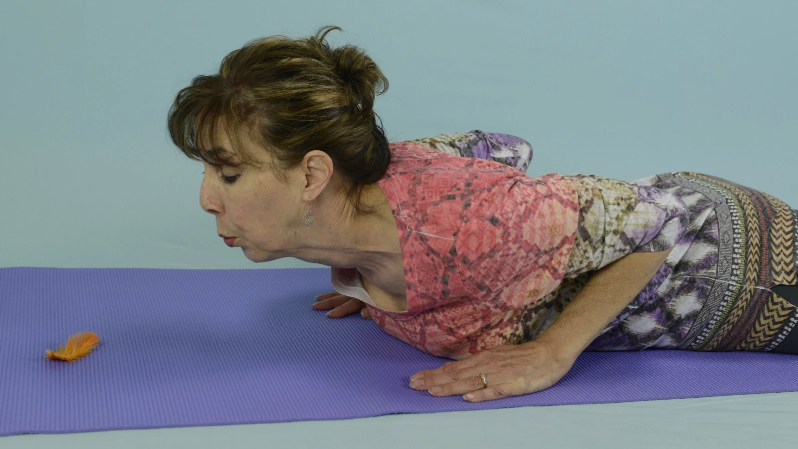 Yoga teacher demonstrating breathing techniques (pranayama) for children 