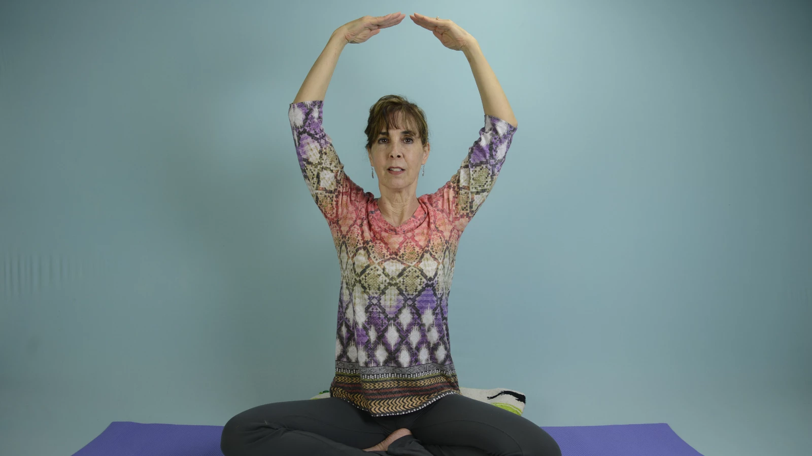 Yoga teacher demonstrating breathing techniques (pranayama) for children 