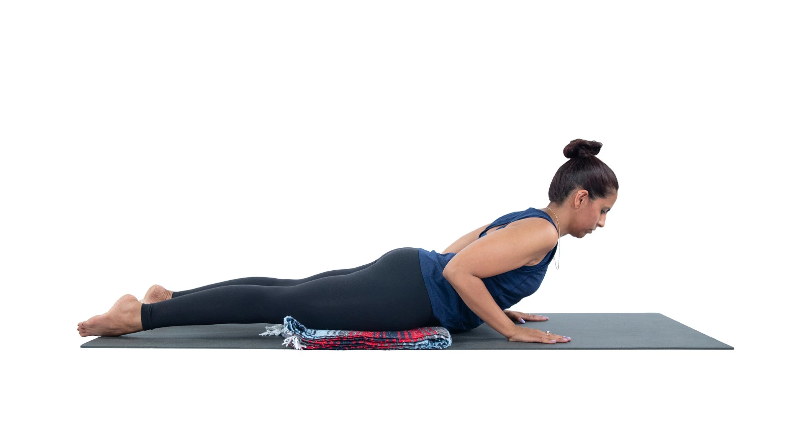 Female yoga student practicing bhujangasana cobra pose