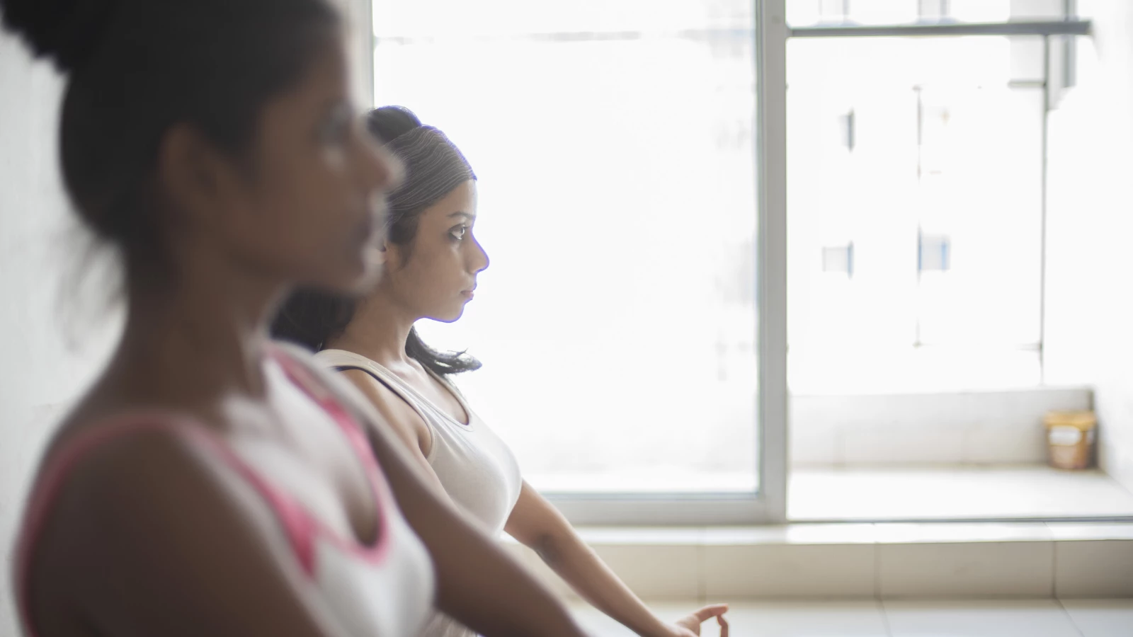 female yoga student practicing seated meditation