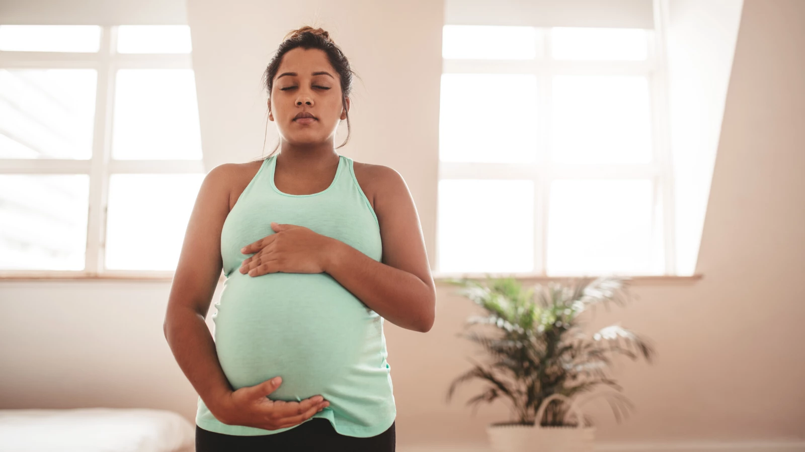 pregnant yoga student practicing meditation