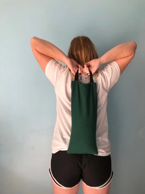 ShoulderStretch with a sand bag, yoga with props, yoga practice tips, yoga and pose variations