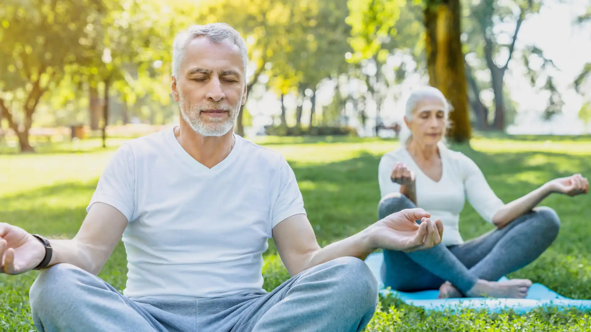 Older beginner yoga yoga students demonstrating how to practice mindfulness meditation