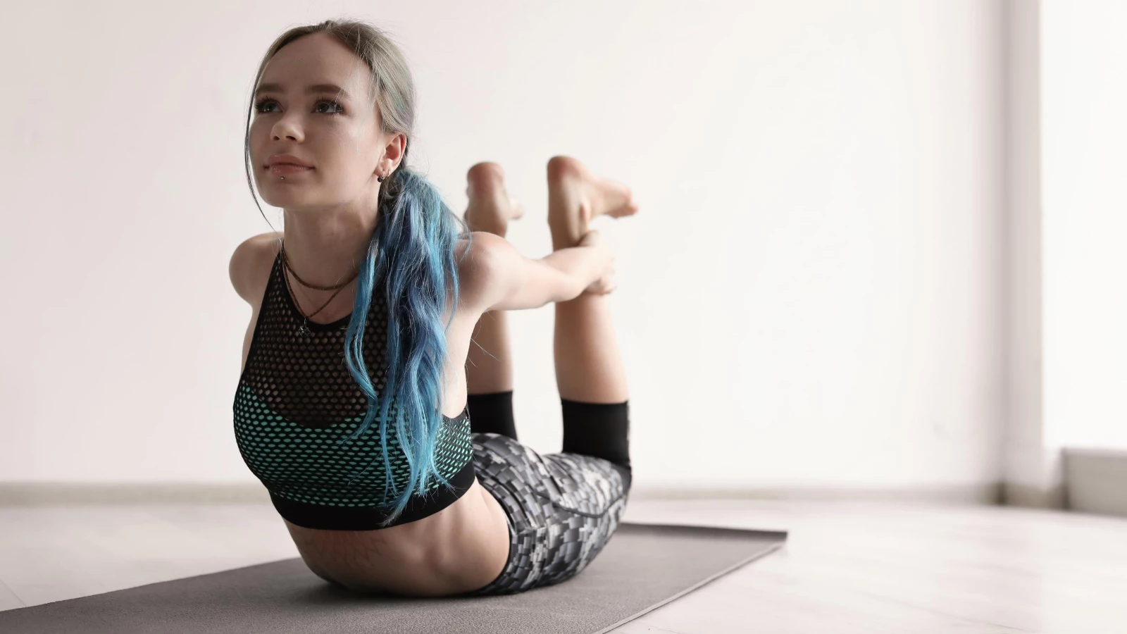 young woman practices yoga poses to help with stress and trauma