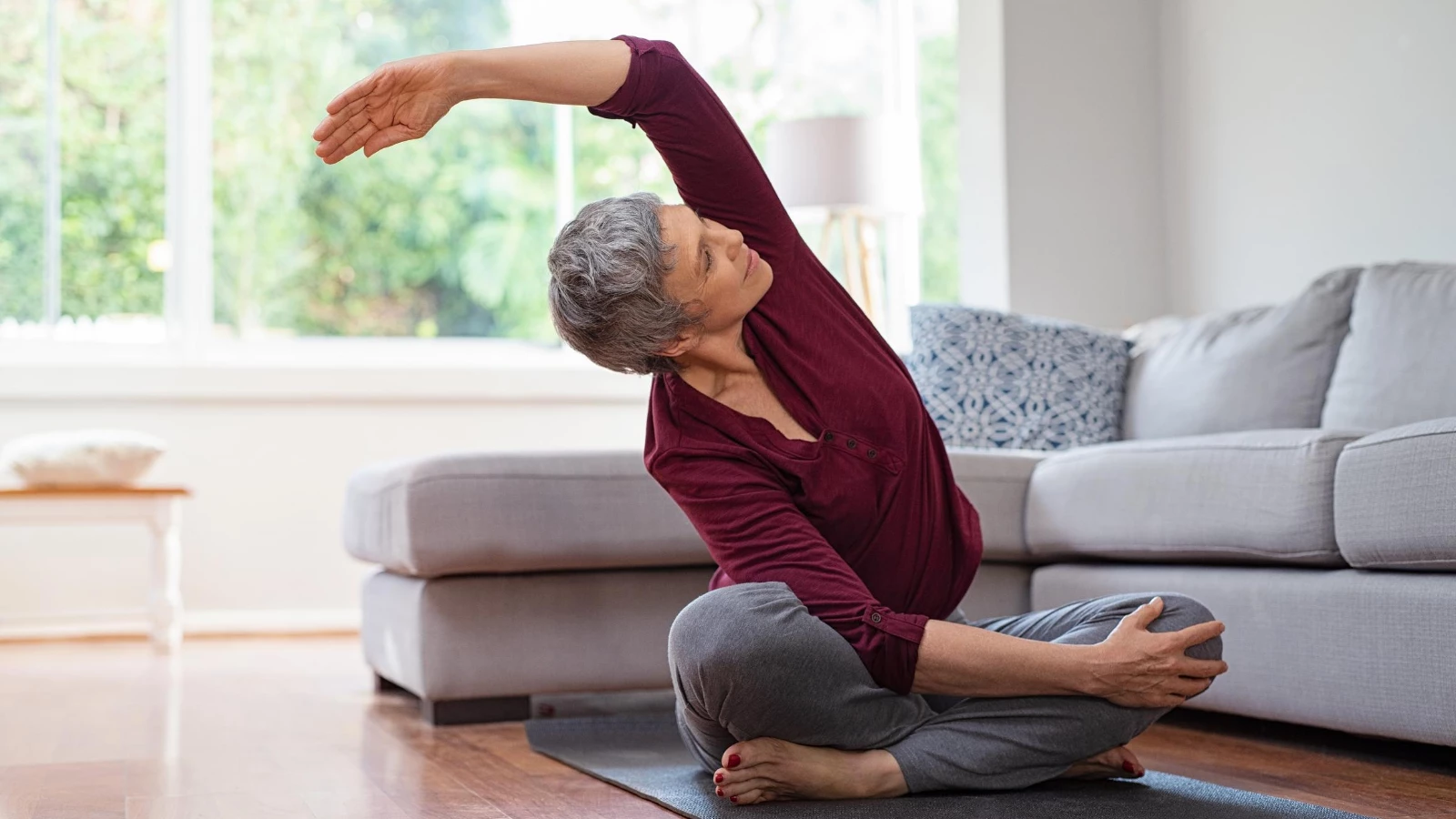 Older beginner yoga student practicing yoga for reducing symptoms of menopause