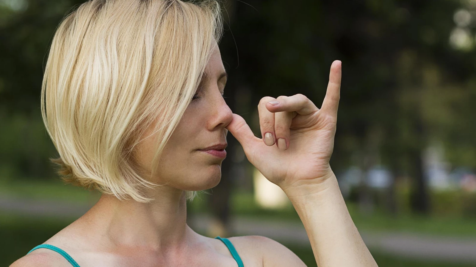 A woman practicing pranayama breathing during yoga practice to experience the benefits of reduced stress and anxiety