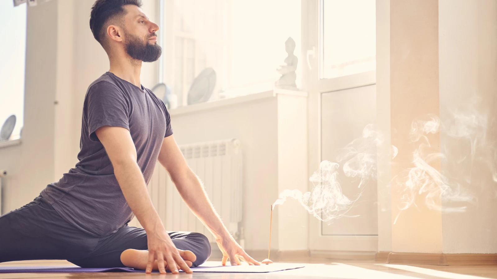 Yoga student experiencing the benefits of practicing ahimsa yoga and mental nonviolence in Pigeon Pose (Sanskrit name: Kapotasana)