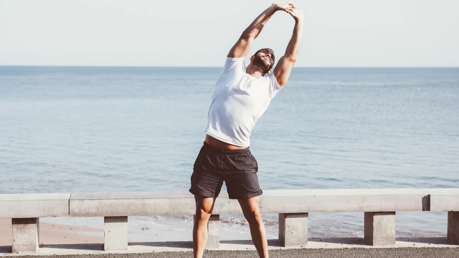 Yoga student practicing Quadratus Lumborum Stretch: Standing Side Bend Pose for the benefits of healthy hips and pelvis