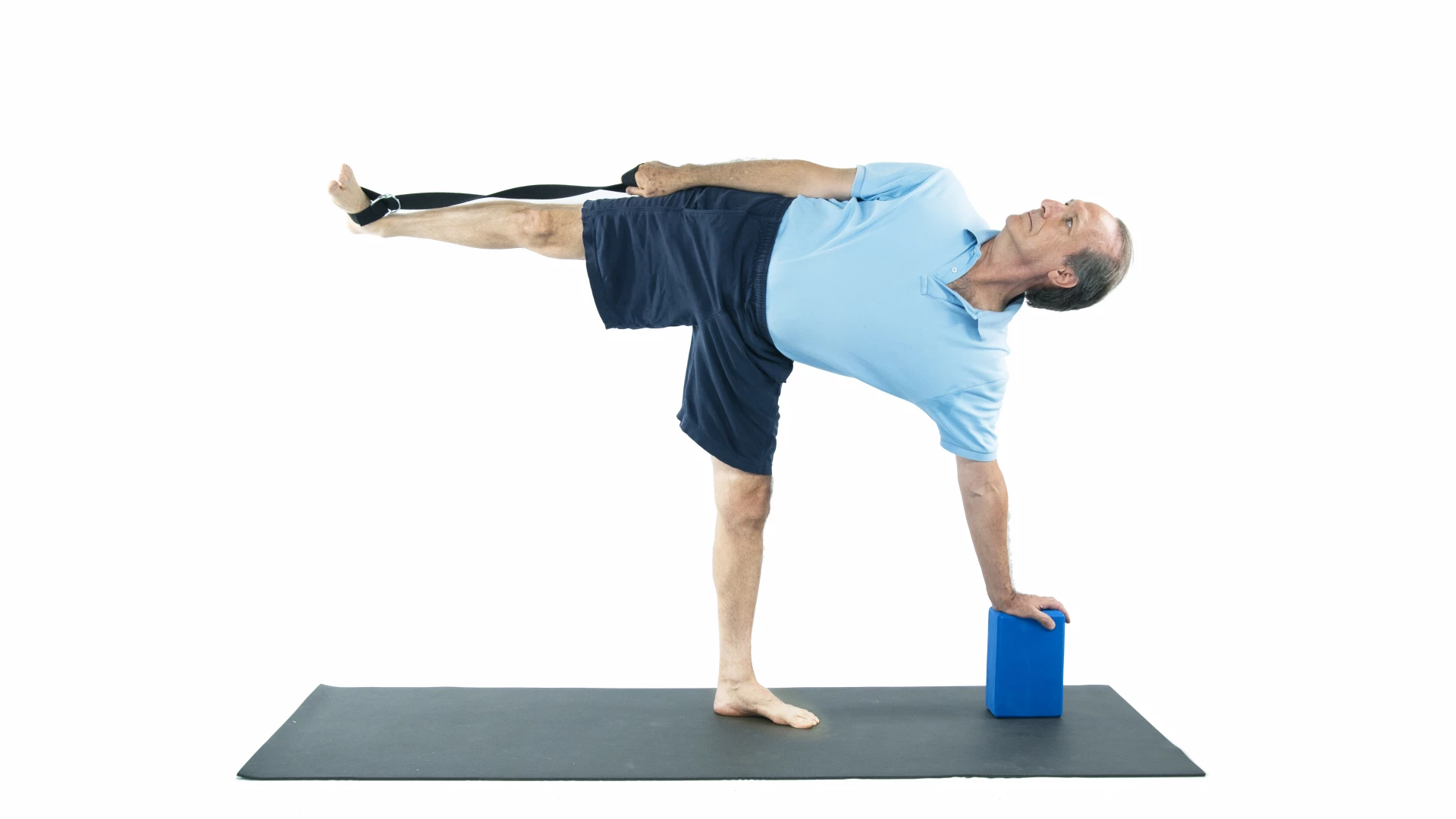 man practicing half moon with yoga props