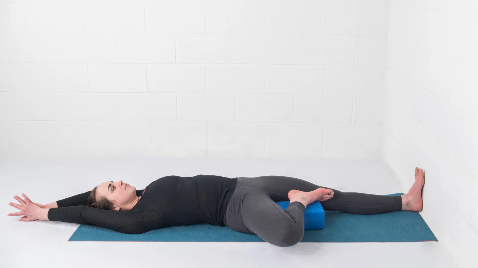 What Is Wall Yoga? The Practice Literally Takes Your Poses To New Heights