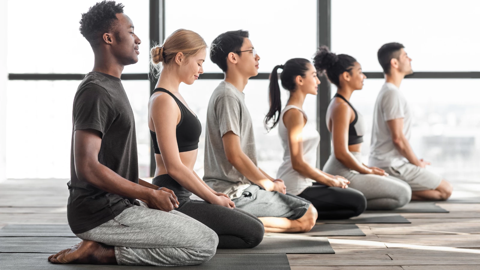 Yoga students at the end of class experiencing the positive effects of saying and meaning the word 