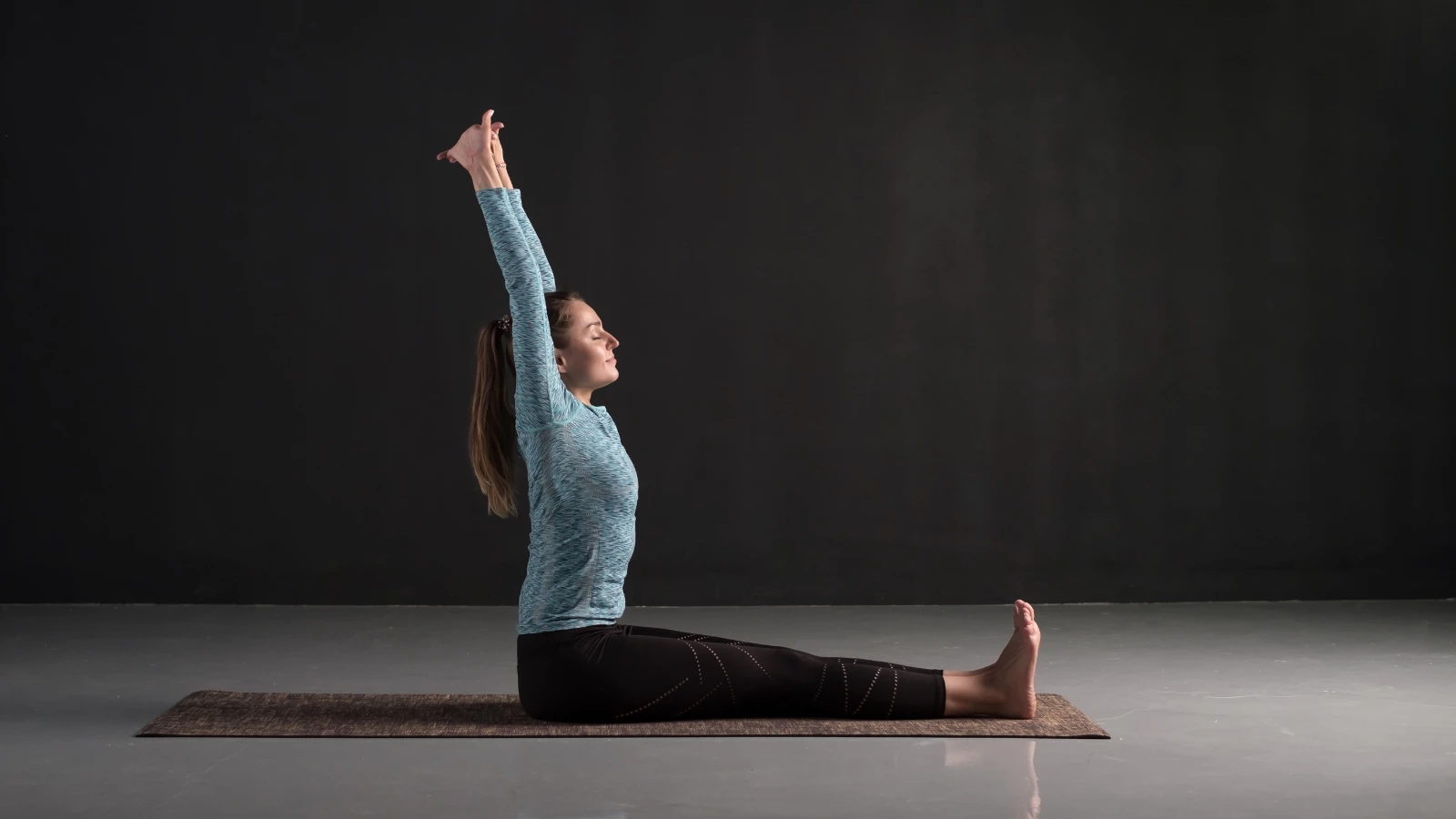 Yoga student practicing Staff Pose (Dandasana) with sensory awareness