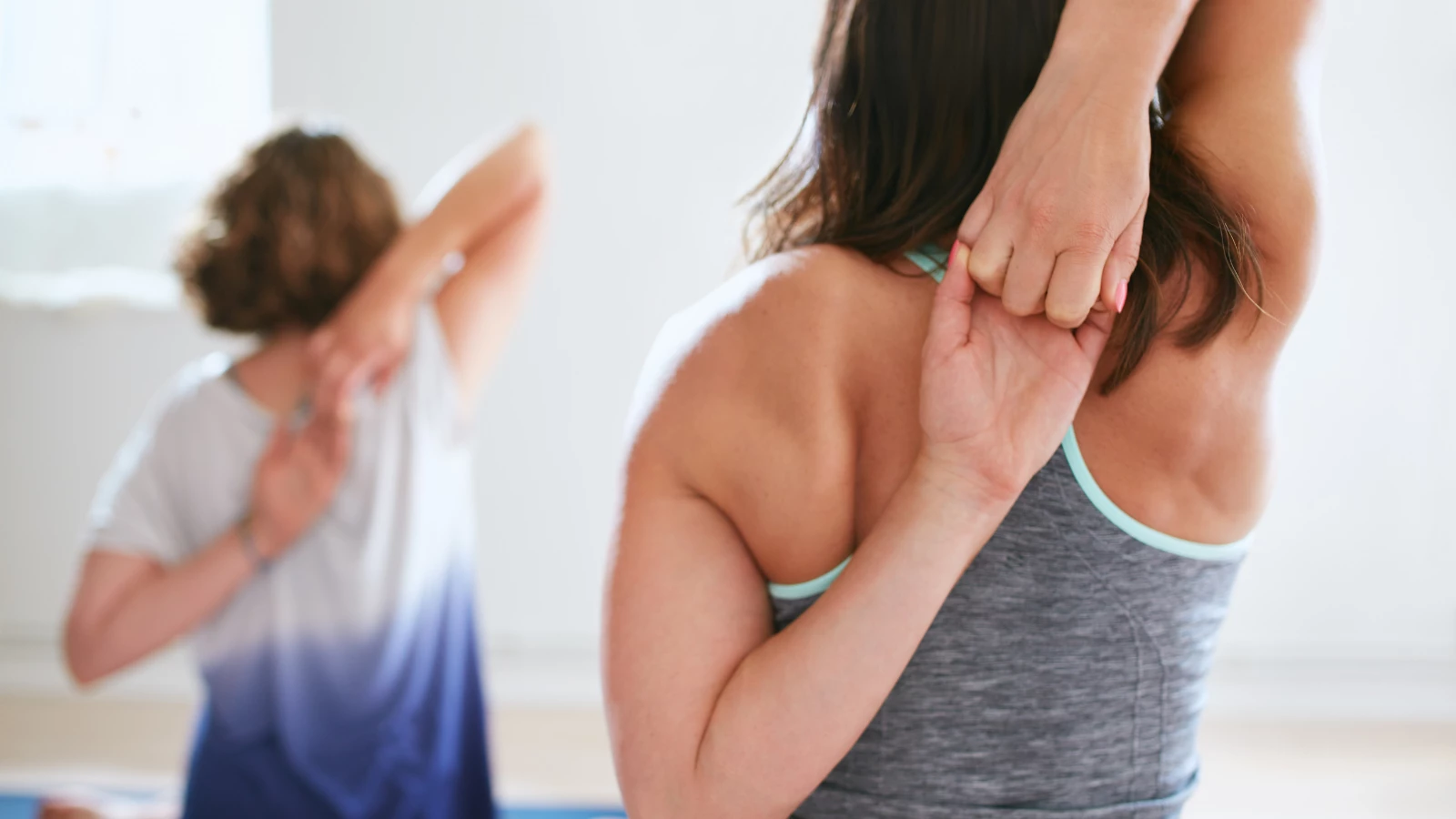 Yoga teacher tips to teach Cow Legs Pose (Gomukhasana) in yoga class with knowledge of movement and anatomical language