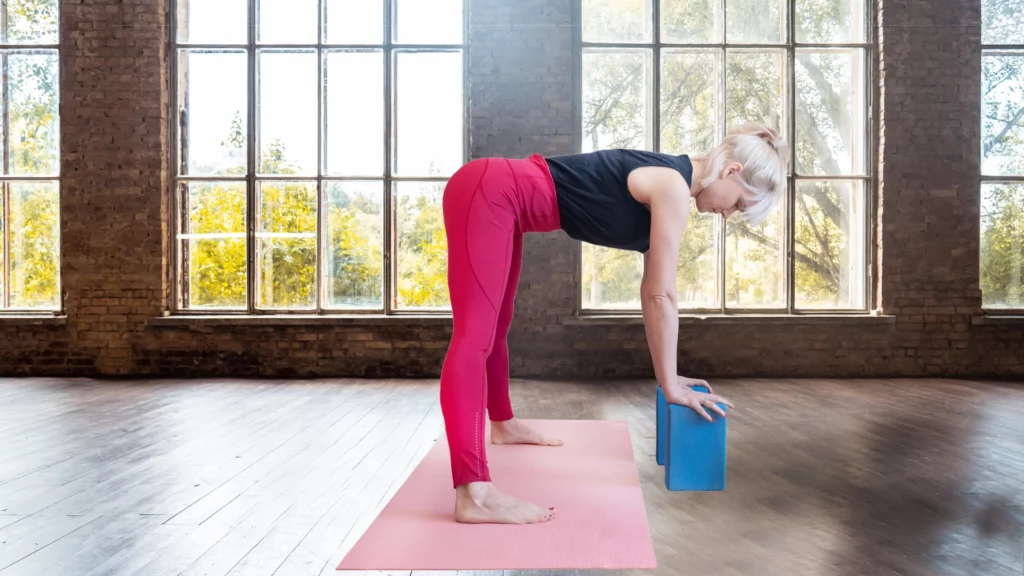 Prasarita Padottanasana variation or Standing Forward Bend with yoga blocks for support. This pose is great for relieving stress and reducing anxiety.