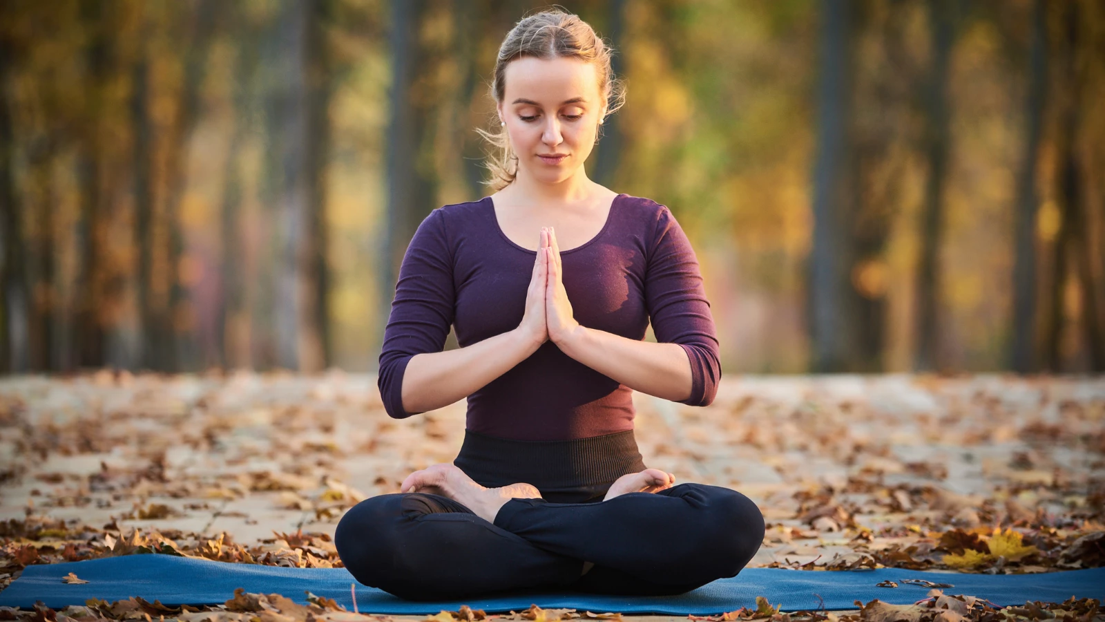 Yoga student finds gratitude in Saucha practice while in Lotus Pose (Padmasana)