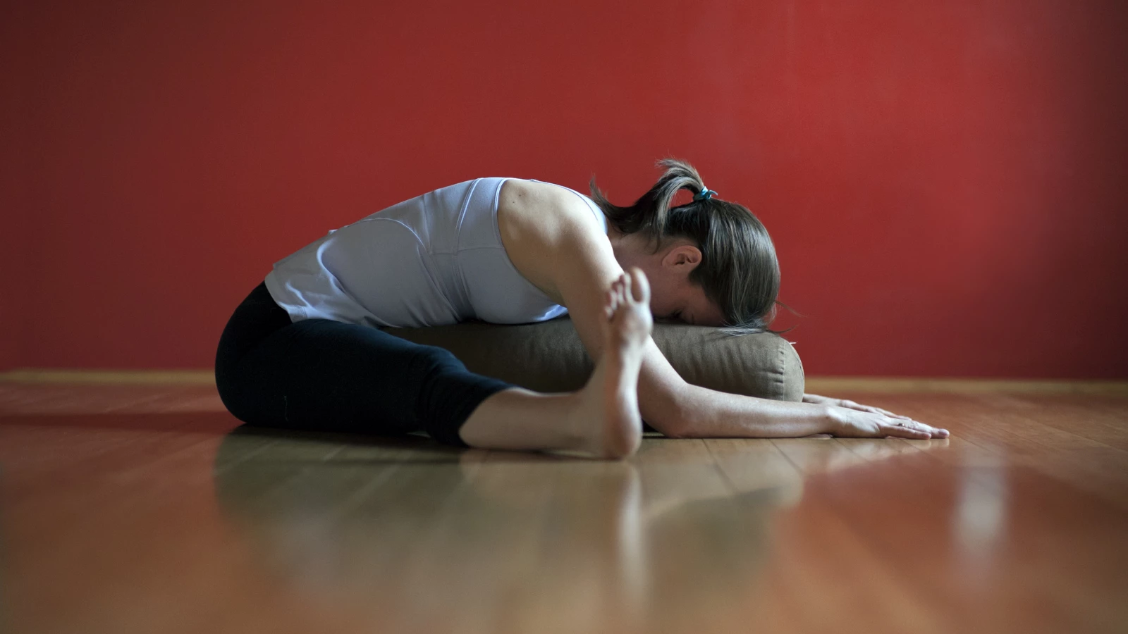 Yoga student experiencing the benefits of calming the body and quieting the mind to reduce stress and improve sleep