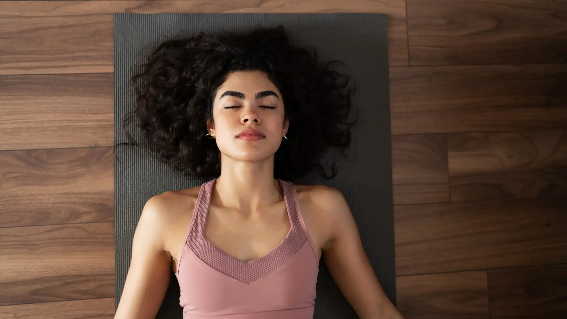 Yoga student practicing Relaxation Pose (Savasana) to reconnect with the self and find inner peace