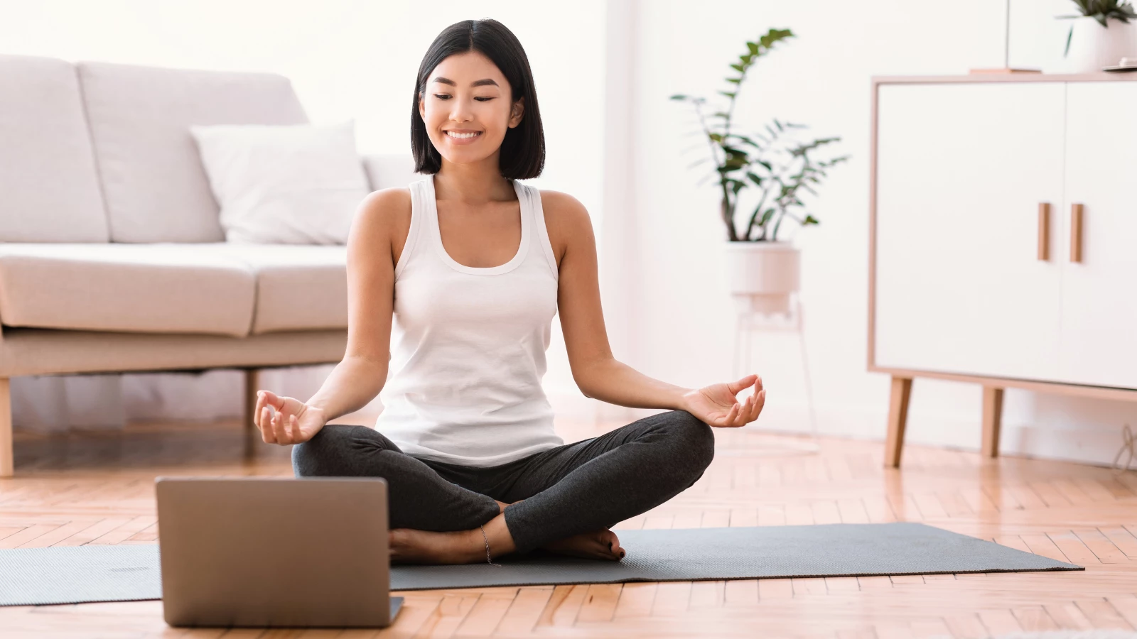 Yoga student experiencing the benefits of meditation to reduce food cravings and obesity