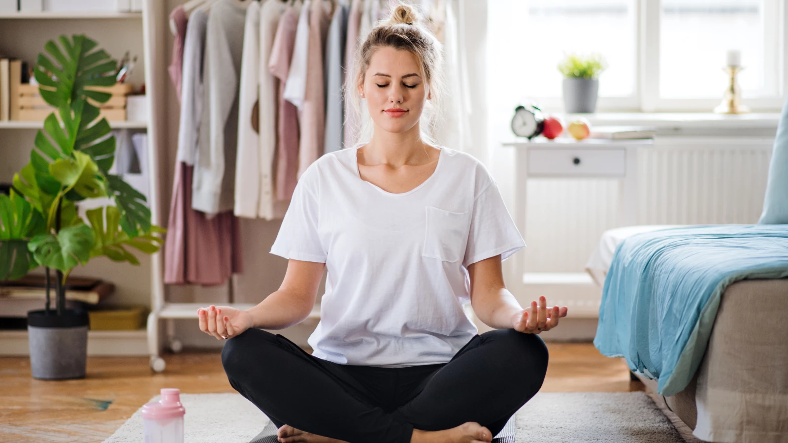 Yoga student practicing meditation to lower the risk of cancer