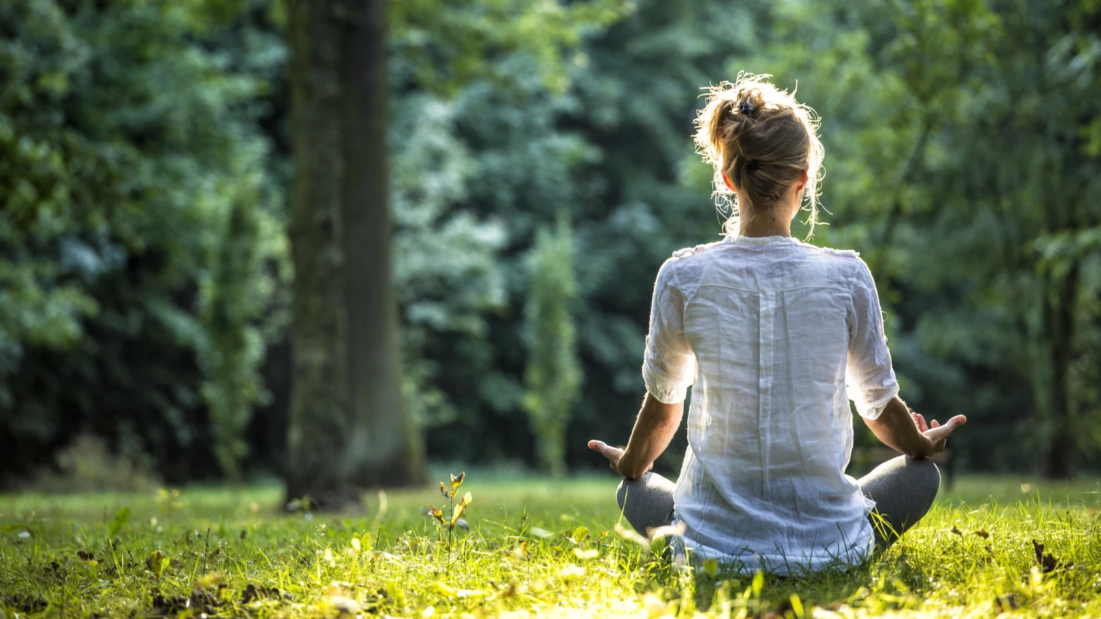 Yoga student experiencing the benefits of practicing meditation to reduce systemic inflammation