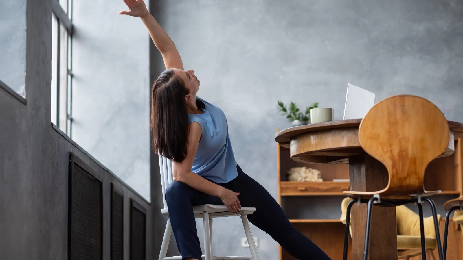 Yoga student practicing Extended Side Angle pose (Utthita parsvakonasana) experiencing the benefits of a shorter workday