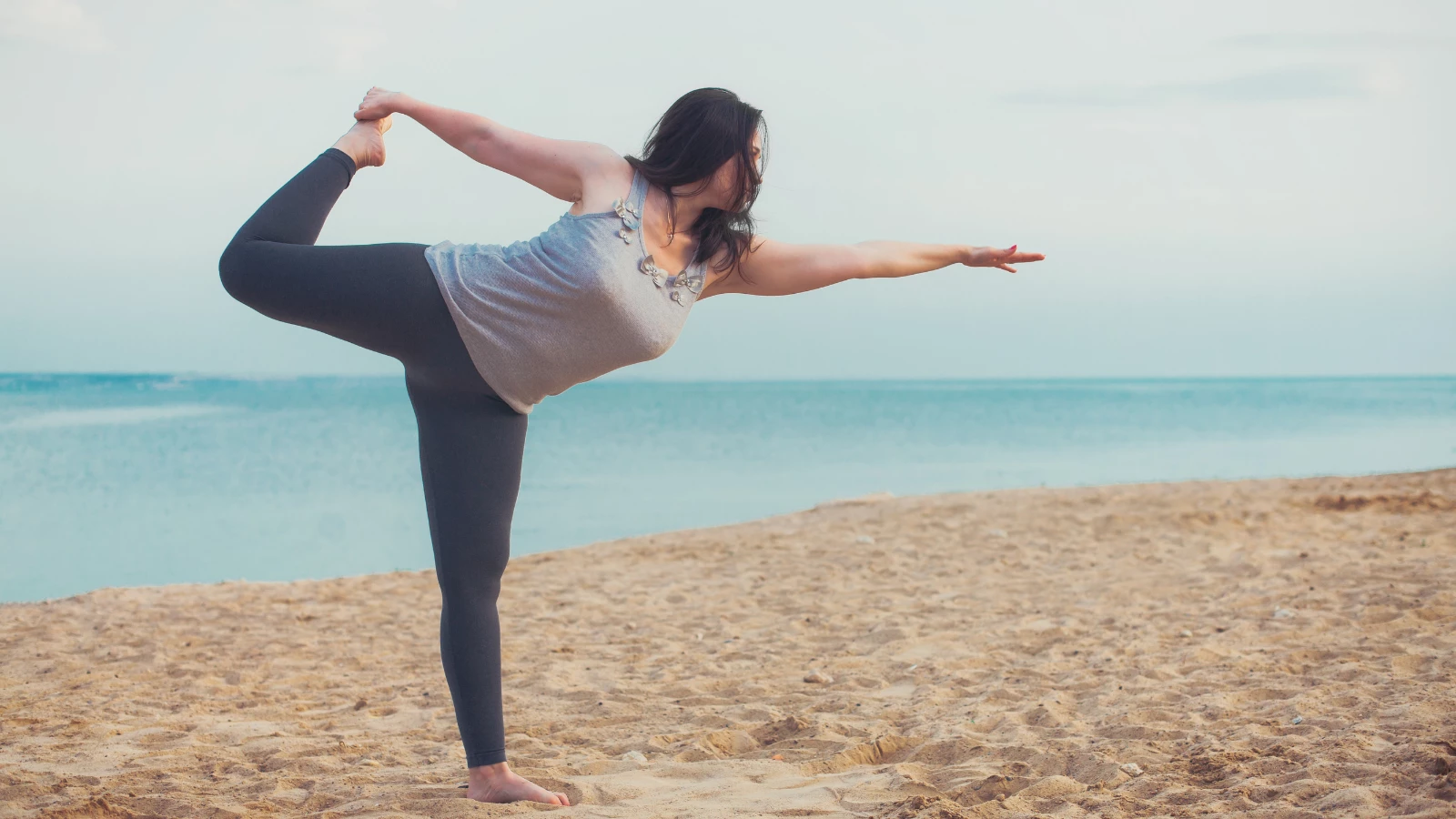 Yoga student practicing Lord of the Dance Pose (Natarajasana) while engaging the senses to interact with the external environment