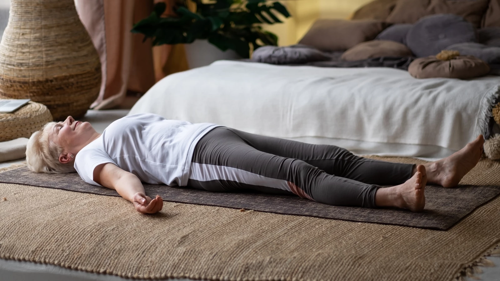  Yoga student practicing simple breath awareness in Savasana Pose to ease suffering and discomfort