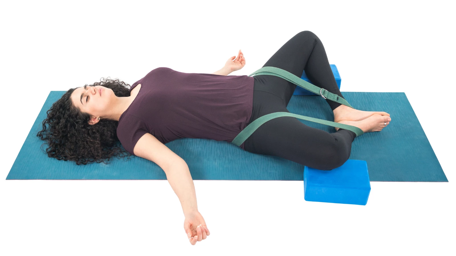 Yoga student experiencing the benefits of practicing Reclining Bound Angle Pose (Supta Baddha Konasana) for pelvic floor health