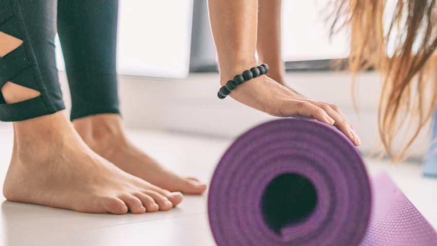 Yoga mat in fitness class for health and wellness including healthy feet