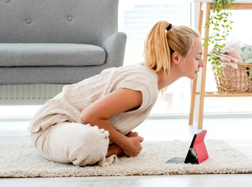 young woman in bound angle pose stimulating her vagus nerve with yoga practice and breathing exercises