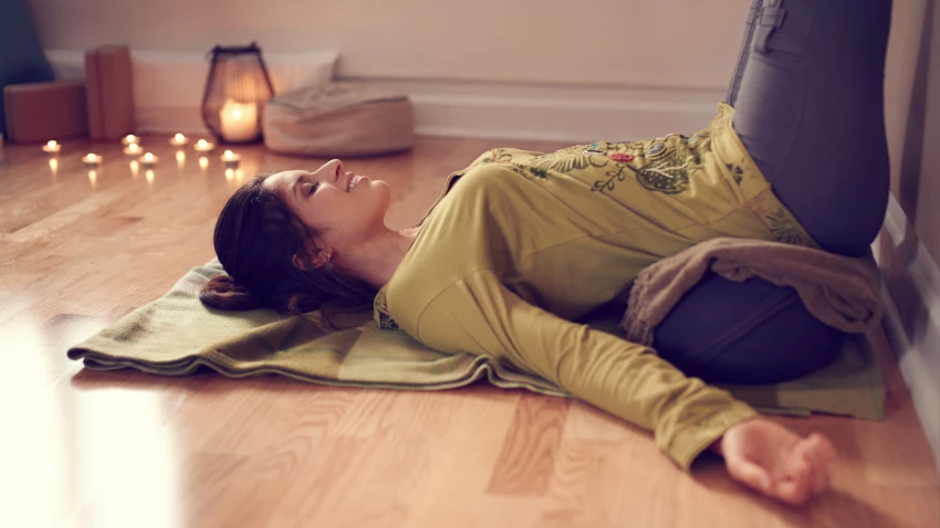 Yoga student and legs up the wall restful pose