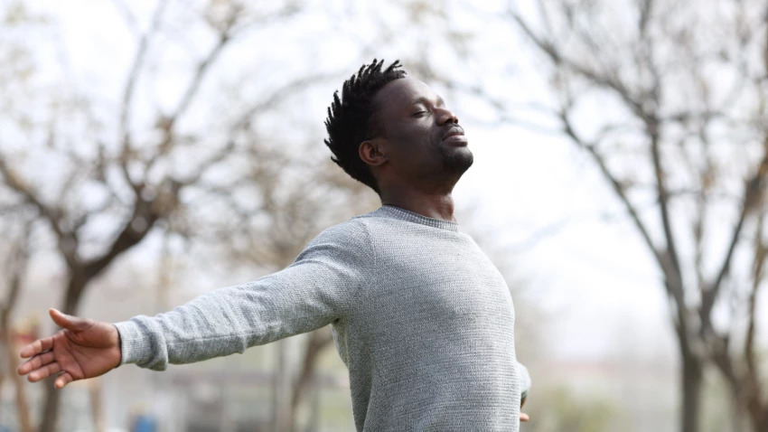 Man in the park feeling the effects of mindfulness practices