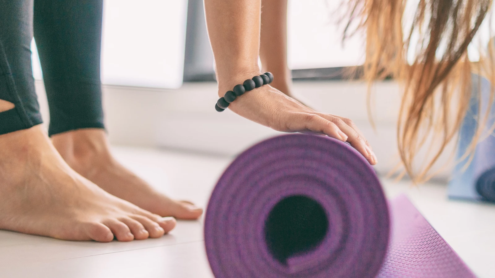 Yoga mat and fitness class closeup of yoga sticky mat and barefoot feet