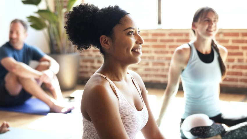 Sportive people enjoying a yoga class