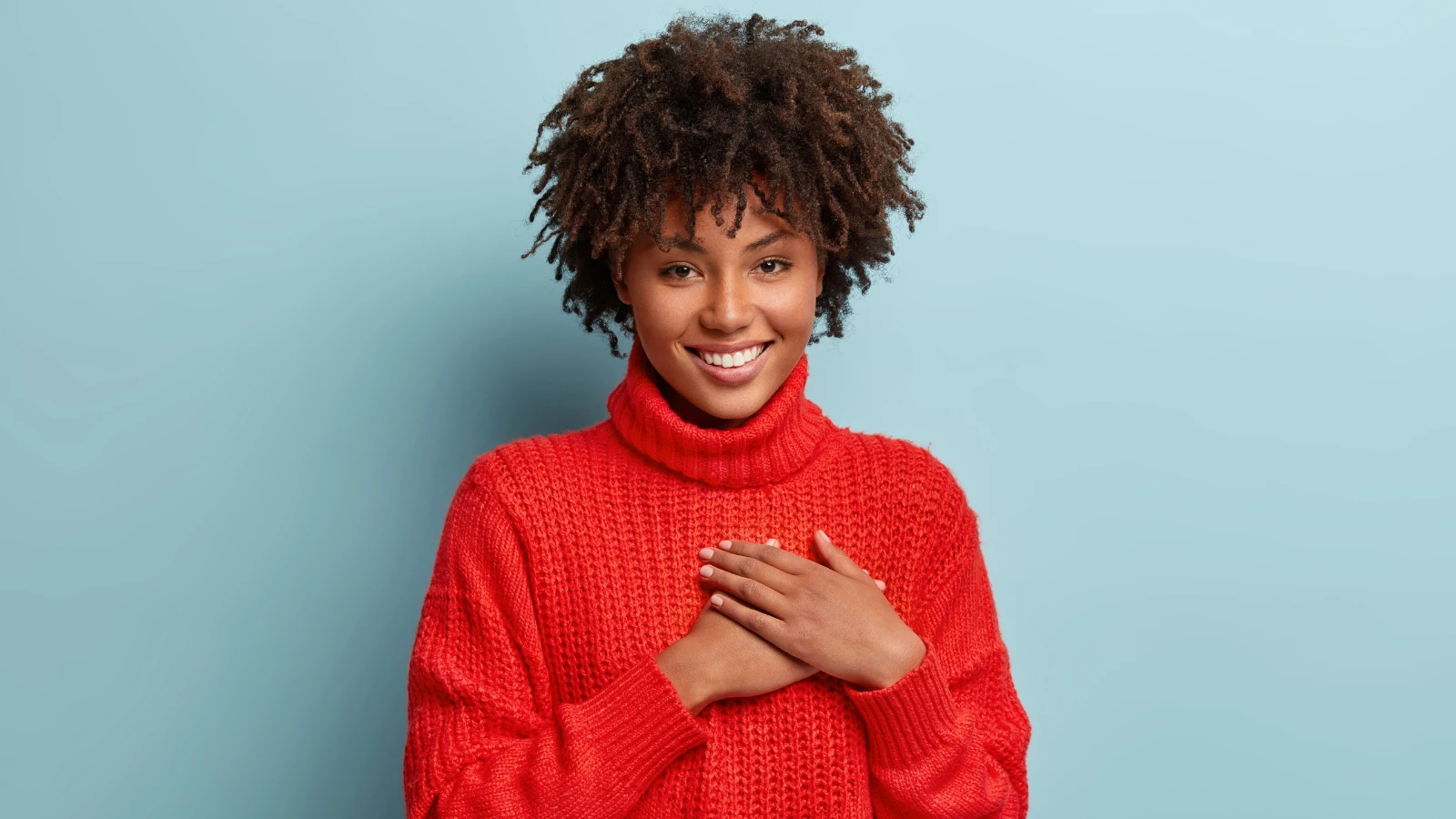 Photo of emotional female demonstrates thankful gesture and practicing gratitude