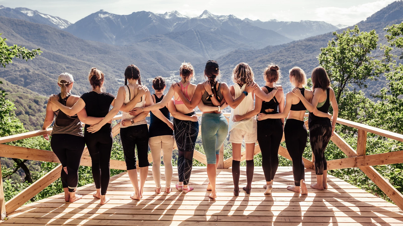 Rear view of a group of active and friendly women doing fitness and yoga together practicing brahma viharas