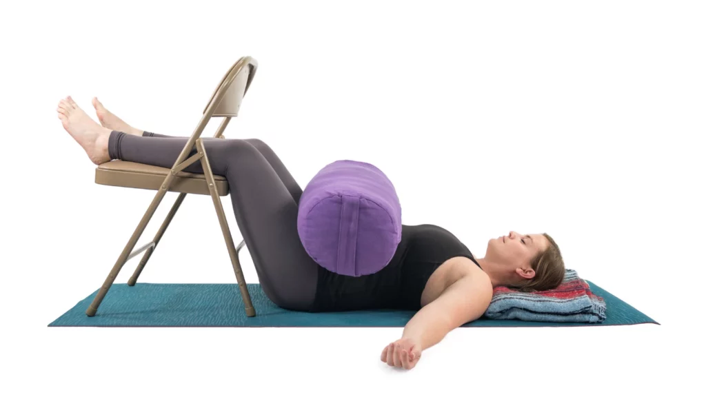 A restorative yoga pose version of Legs-Up-the-Wall but this variation uses a chair.