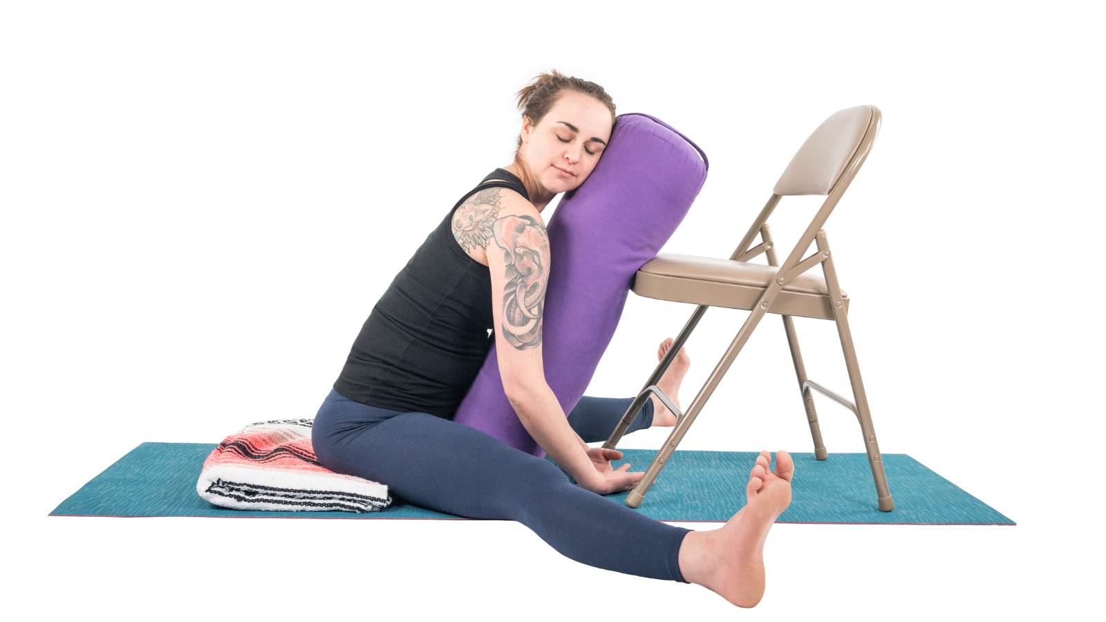 
A restorative version of Upavista Konasana practiced with the help of a chair and support of a bolster
