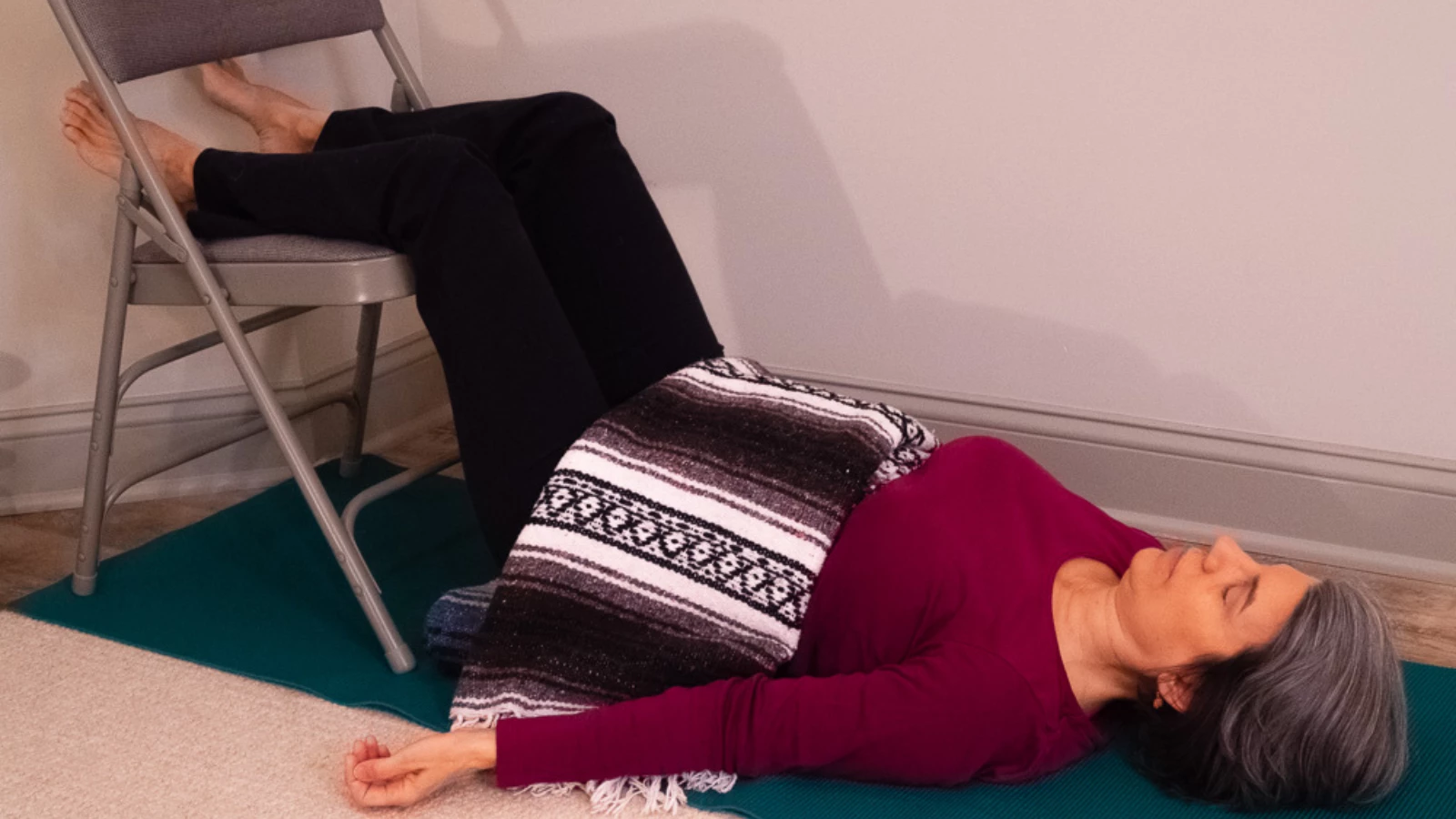 A variation of Viparita Karani or Legs Up the Wall Pose practiced with a chair