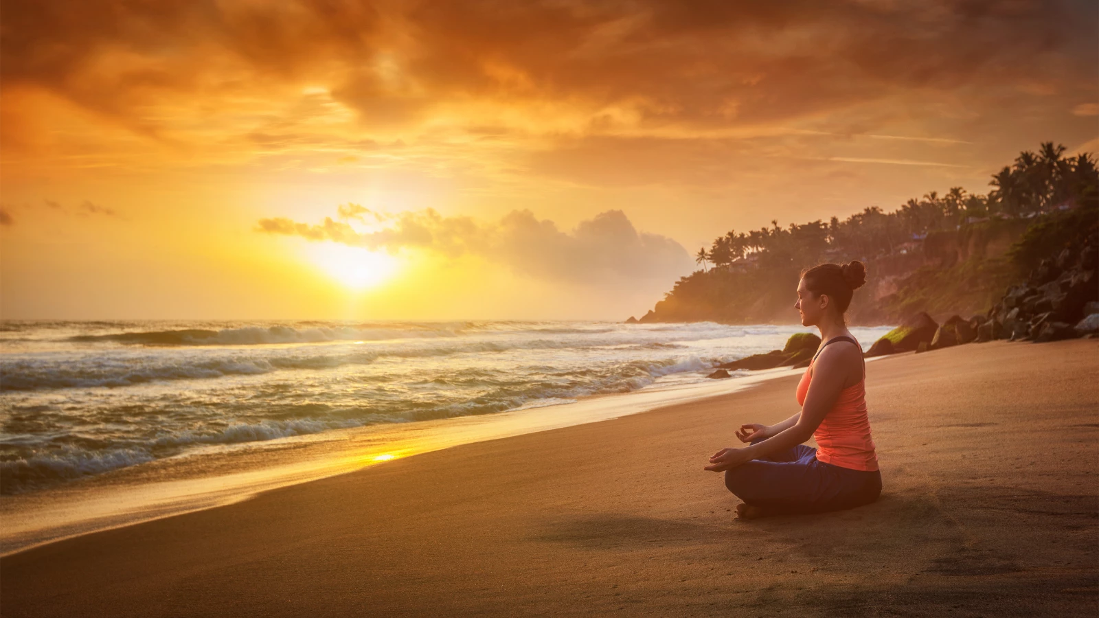 woman doing yoga, meditating and relaxing in Padmasana Lotus Pose) with chin mudra outdoors