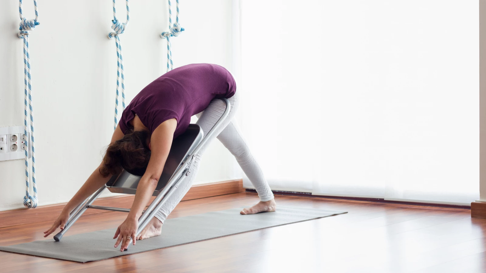 Forward Folds in yoga with the help of a chair.