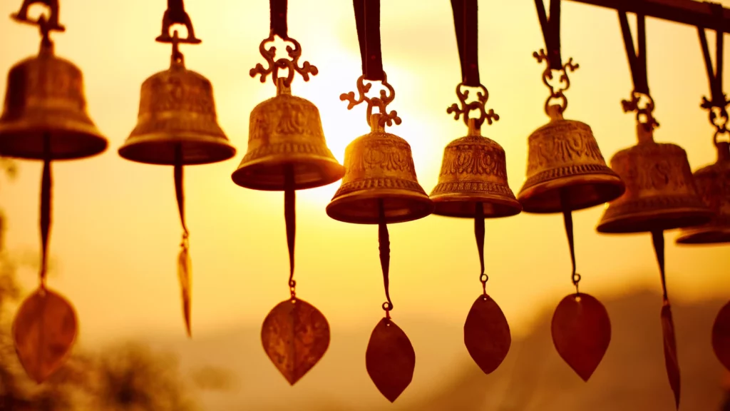 Nepali traditional Bells over the sun at sunset. Mindfulness reminders