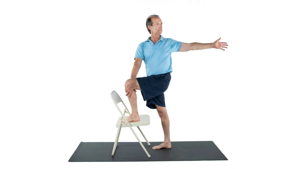 Marichyasana Pose practiced with a chair to support a gentle twist for yoga for osteoporosis, spinal well-being and fracture prevention.