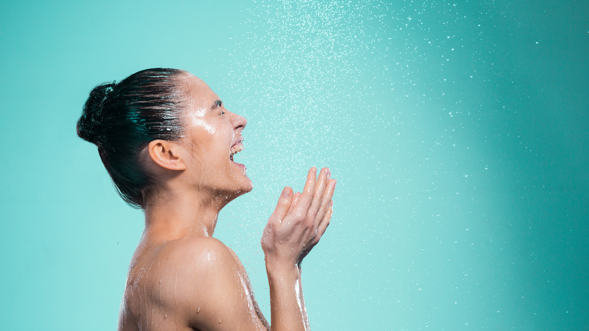 Woman enjoying the cold water in the shower as an early morning wake up routine.