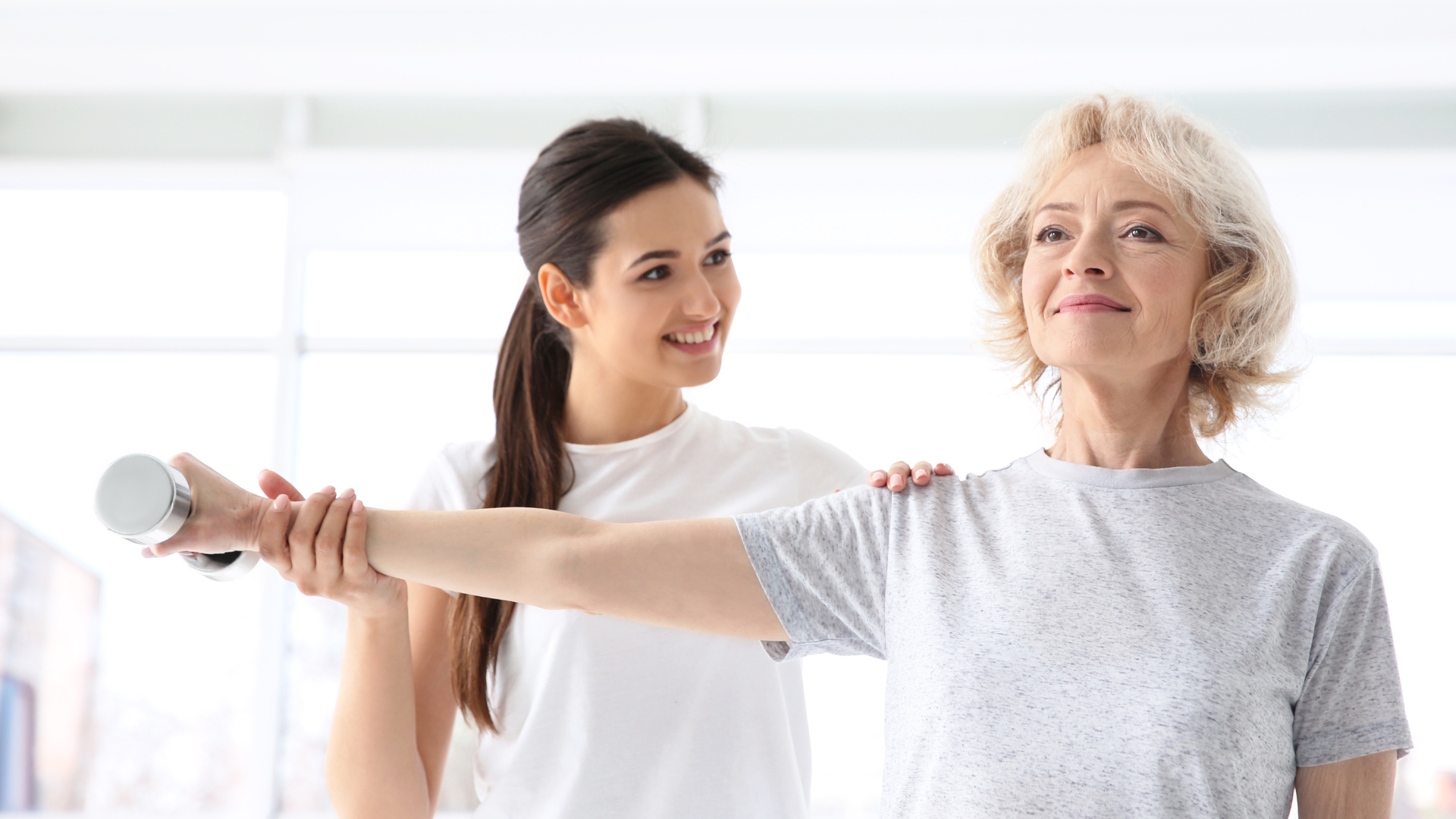 Physiotherapist working with mature patient in modern clinic.